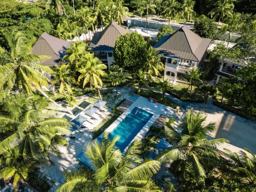 an overhead view of a resort with a pool and palm trees at Indian Ocean Lodge in Grand'Anse Praslin