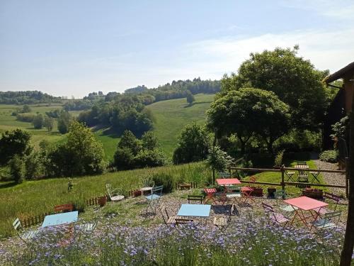 a garden with tables and chairs in a field at I Conti della Serva in Cinzano