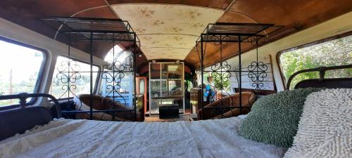 a bedroom with a bed in the back of a bus at Al Aire Libre in San Rafael