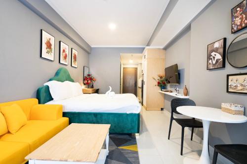 a hotel room with a bed and a couch at Otis Soho Saigon Balcony Apartment in Ho Chi Minh City