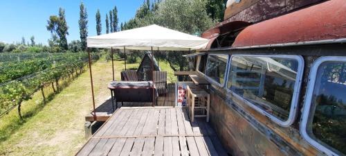 a wooden deck with an umbrella and chairs on a house at Al Aire Libre in San Rafael