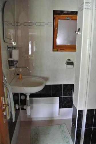 a bathroom with a sink and a mirror at Apartmán Margarétka in Liptovský Trnovec