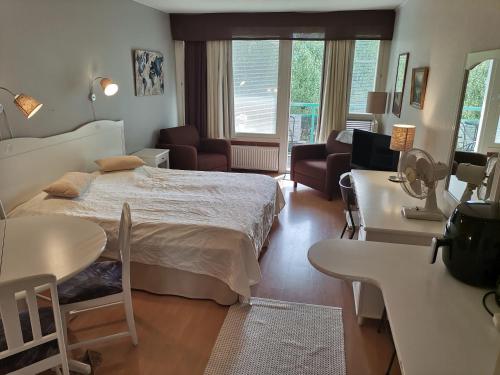 Un dormitorio con una cama y una sala de estar. en Huoneisto 452 Span viereisessä talossa 4krs, en Kilvakkala