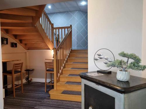 a staircase in a room with a stair case at Logis Hotel Schaeffer- Restaurant Le Saint Georges in Serrières