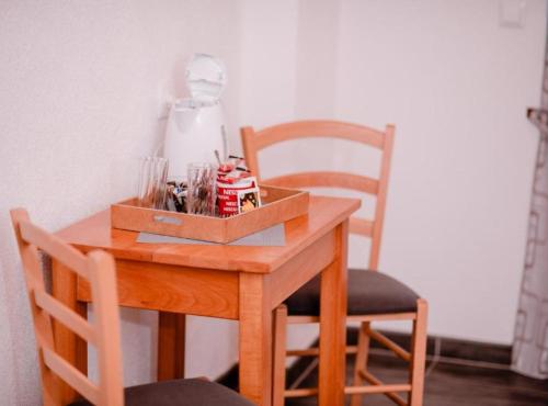 a wooden table with a box on top of it at Mountain Serenity Rooms in Korenica