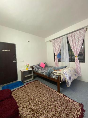 a bedroom with two beds and a window at Samendo-Retreat Homestay in Sukhia Pokhari