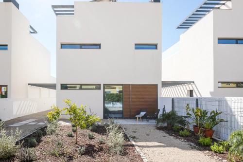 an external view of a white building with plants at Casa do Colhereiro with Private Pool in Luz de Tavira in Luz de Tavira