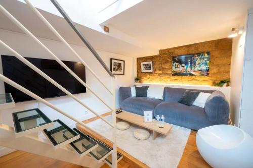 un salon avec un canapé bleu et une table dans l'établissement Cozy Artist Loft, à Paris