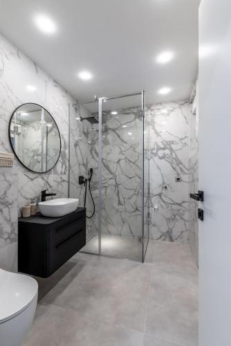 a bathroom with a shower and a toilet and a sink at Bracera Luxury Apartments in Slatine