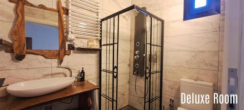 a bathroom with a sink and a glass shower at Manastırhan Otel Kazdağları in Balıkesir