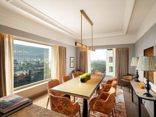 a dining room with a table and a large window at Pullman Chennai Anna Salai - Premium Brand By Accor in Chennai