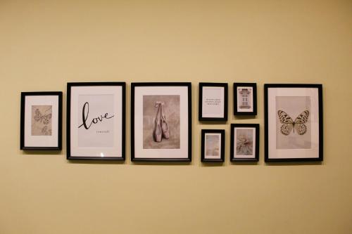 a group of framed pictures on a wall with butterflies at BlackWoody Contemporary Rooms - Napoli Centro Storico Via Toledo in Naples