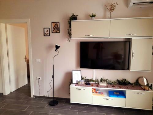 a living room with a flat screen tv on a wall at Azure Sands Golem in Golem