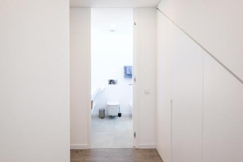 a white room with white walls and a hallway at Casa do Colhereiro with Private Pool in Luz de Tavira in Luz de Tavira