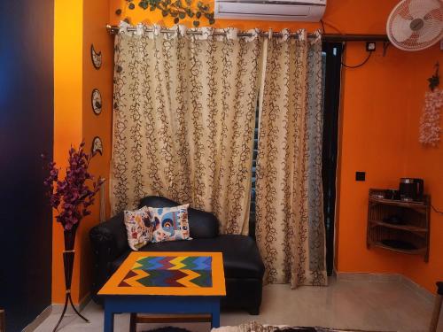 a living room with a chair and a table at Minx Nest in Nilmatha