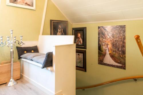 a room with pictures on the wall and a bed at Photoeverhome in Bengtsfors