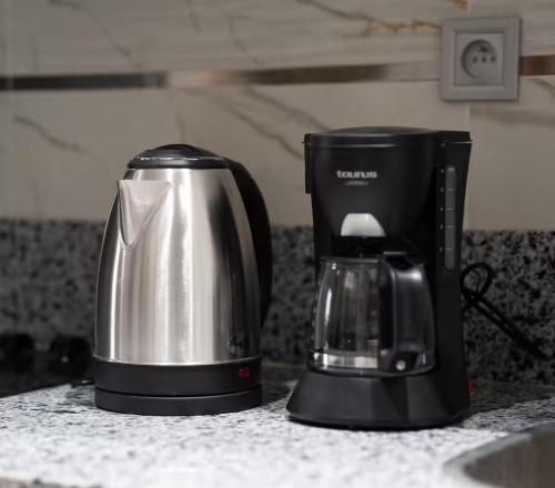 a coffeemaker and coffee maker on a kitchen counter at Nice & Comfortable 2BHK panoramic balcony with swimming pool in Aïn Harrouda
