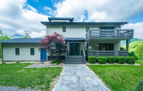 a house with a blue door and a green at Mountain View 3BR with Sunroom, Close to Ski and Trails in Maggie Valley