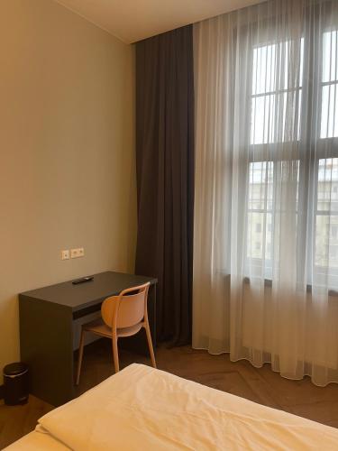 En eller flere senge i et værelse på Motel Blue Messe