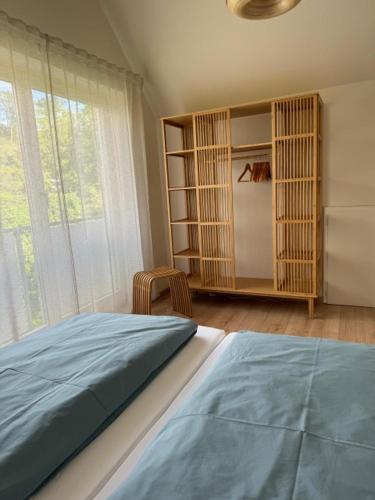 a bedroom with a bed and a large window at SEEgold in Unteruhldingen