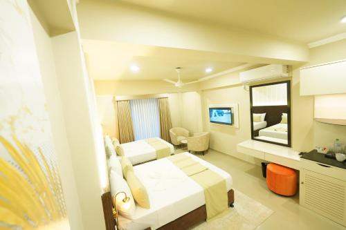 Postel nebo postele na pokoji v ubytování Hotel Grand Amanee