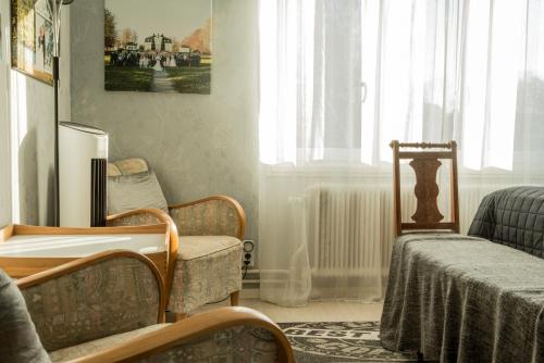 a living room with two chairs and a radiator at Photoeverhome in Bengtsfors