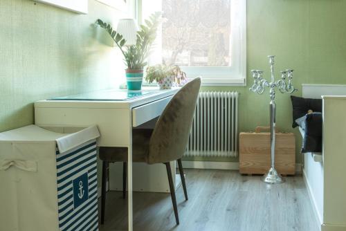a room with a desk with a chair and a window at Photoeverhome in Bengtsfors