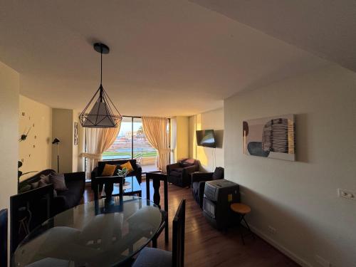 a living room with a glass table and a dining room at San Alfonso del Mar - Algarrobo Valparaiso in Algarrobo