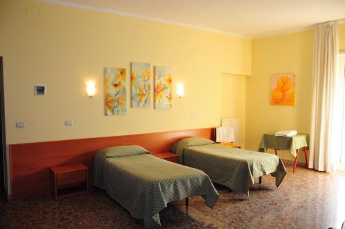 Кровать или кровати в номере Albergo Casa Lupi