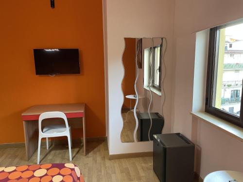 a room with a desk and a table and a window at Stanza Socrate in Corigliano Calabro