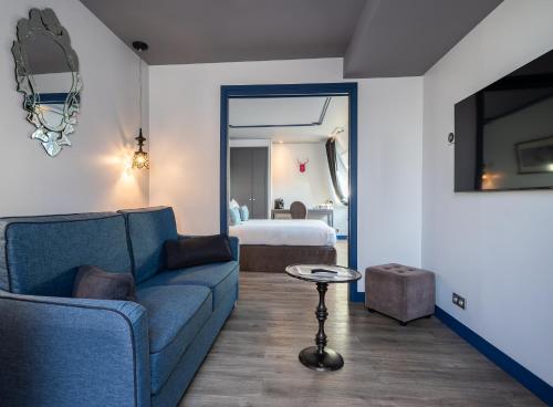 a living room with a couch and a bed at Hotel Mademoiselle in Paris