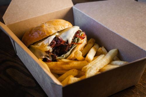 a sandwich and french fries in a cardboard box at Black Horse Hotel in Grassington