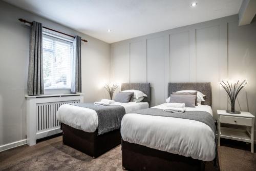 a bedroom with two beds and a window at Black Horse Hotel in Grassington