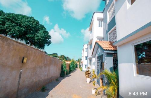 an alley between two buildings next to a wall at Haven Apartments in Malindi
