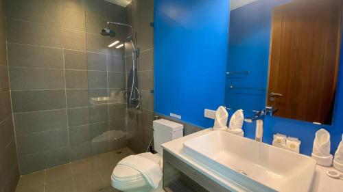 a bathroom with a sink and a toilet and a mirror at Villa Azula - Stunning Seaview in Ban Bang Po