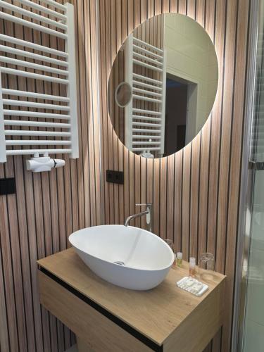a bathroom with a sink and a mirror at Hotel Modena in Bad Steben