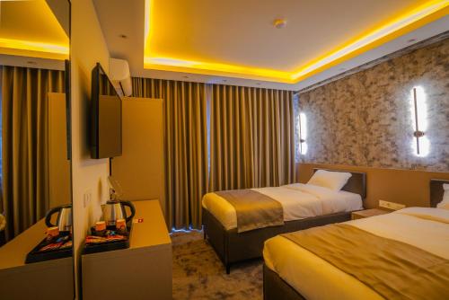 Кровать или кровати в номере Huzur Apart Hotel