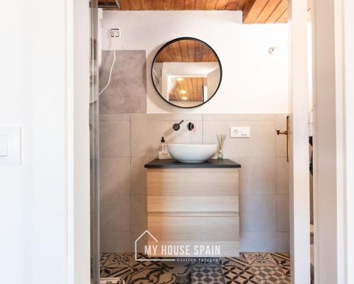 a bathroom with a sink and a mirror at MyHouseSpain - Acogedor apartamento con terraza in Cudillero