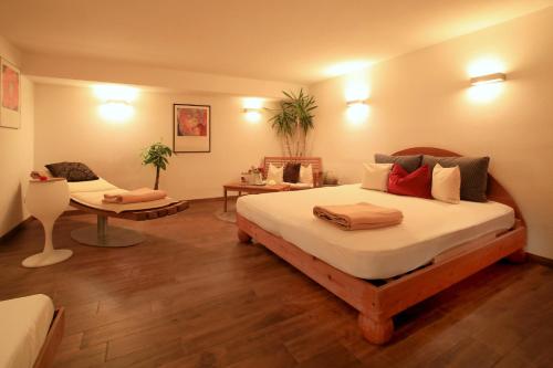 a bedroom with a large bed and a couch at Ferienhaus Viktoria in Abfaltersbach