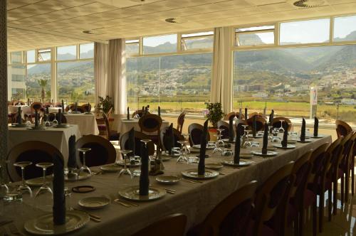 a long table in a room with tables and chairs at Prestige Hotel & Spa in Tetouan