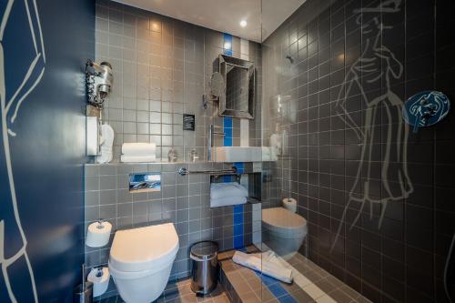 a bathroom with a toilet and a shower at Hotel Mademoiselle in Paris
