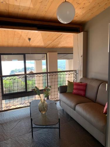 a living room with a couch and a table at Villa Libecciu in Sainte-Lucie de Porto-Vecchio