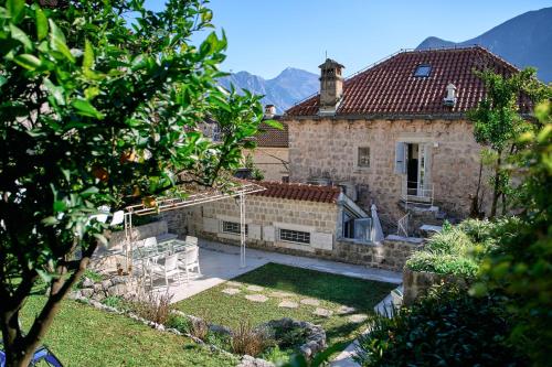 a stone house with a view of a yard at Waterfront Historical Villa Perast in Perast