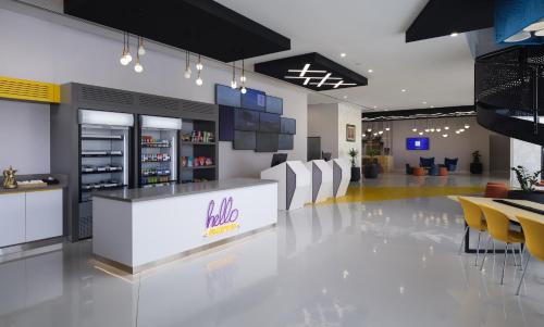a restaurant with a bar with white chairs and tables at Studio M Muscat in Muscat