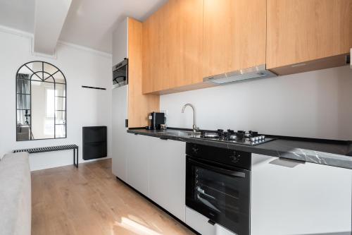 a kitchen with a sink and a stove at AeroPrime - LOFT in Tunari