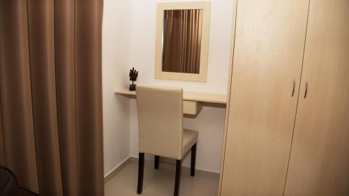 a white desk with a chair and a mirror at Lagada Resort in Makry Gialos