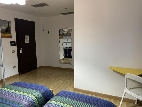 a room with a bed and a desk and a closet at Stanza Nietzsche in Cosenza