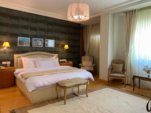 a bedroom with a large bed with a black wall at Luxury villa with swimming pool and garden in Sheikh Zayed