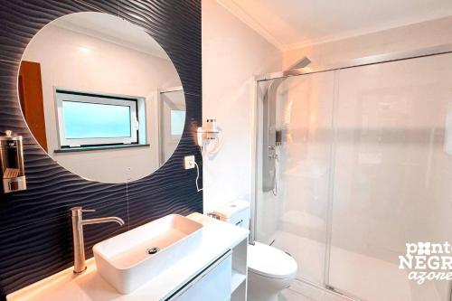 a bathroom with a sink and a mirror at Quinta de São José by PontaNegraAzores in Angra do Heroísmo