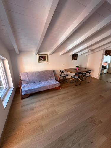 a living room with a bed and a table at Nave San Rocco, Trentino in Nave San Rocco